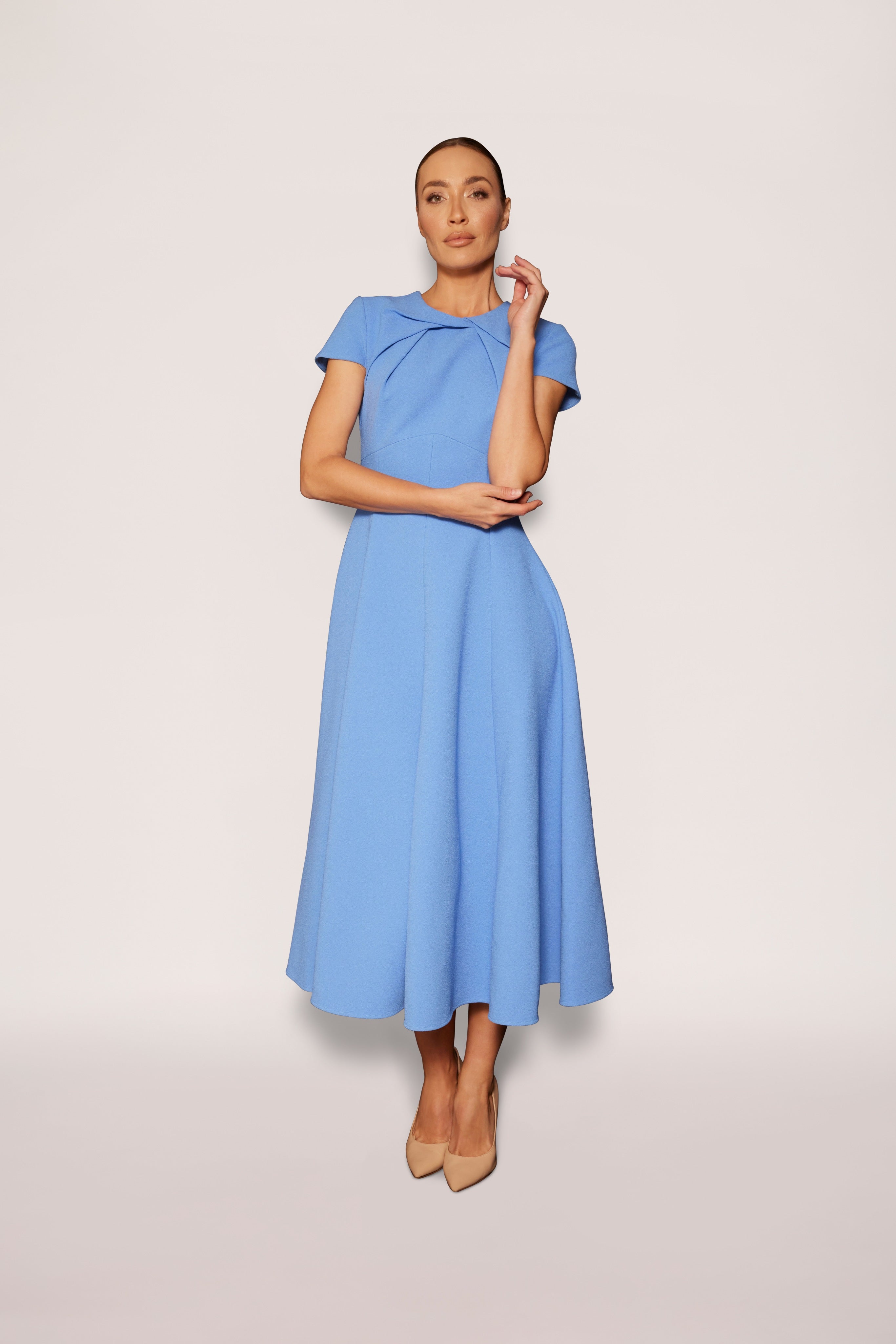 Woman wearing a light blue dress on a white background